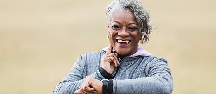 Senior woman checks her heart rate after a run outside.